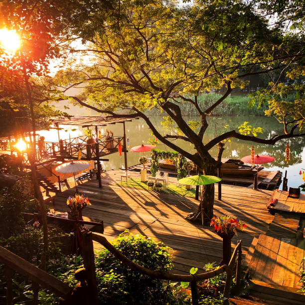 istock the old house,big tree and sunset at the river 1160338383