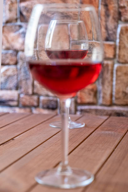 istock two glasses of red wine on a wooden table 1160339897