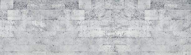 Tuff stone block wall wide texture. Gray rough masonry panorama. Long grunge background
