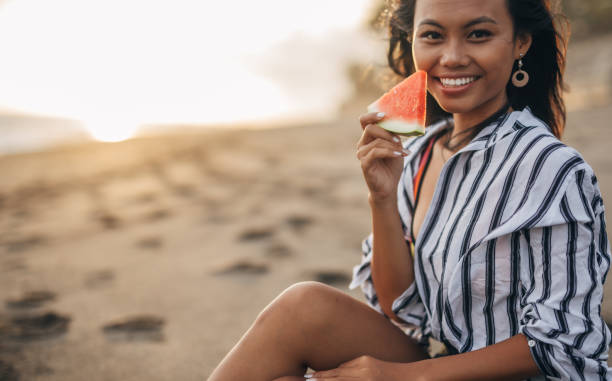 istock Asian woman eating watermelon 1160342286