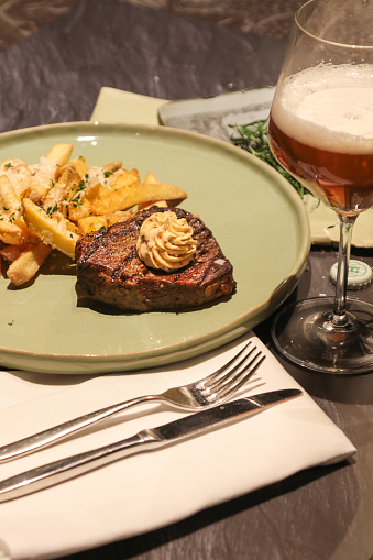 Steak and Fries with cutlery and beer