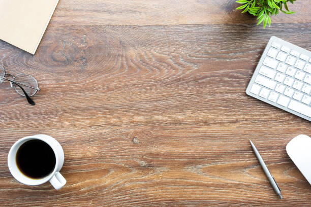 istock Wood office desk table with computer tools, cup of coffee and supplies. Top view with copy space, flat lay. 1160349916