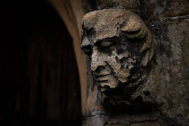 a stone gargoyle attached to a church doorway