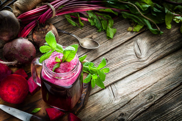 istock Healthy drink: beet juice on rustic wooden table with copy space 1160358291