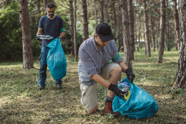 istock Father and son volunteers cleaning park 1160360784
