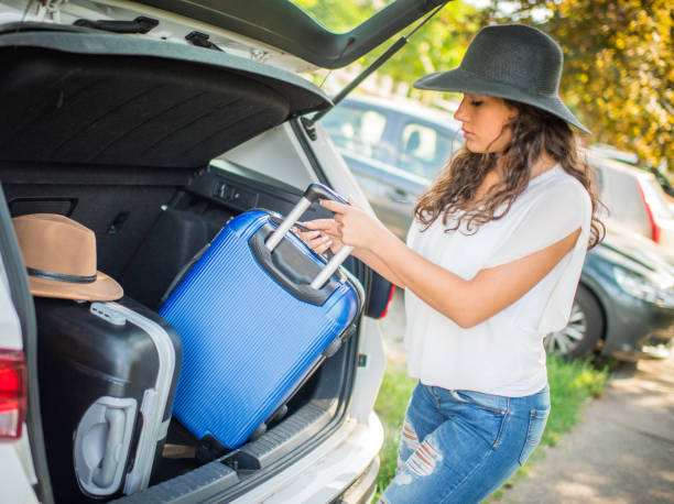 istock Girl packing car with suitcase 1160362967