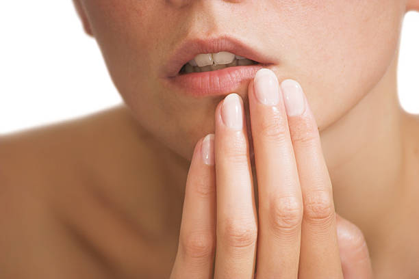 istock female lips and fingers 116036505