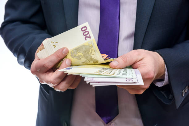 istock Man in suit counting euro banknotes isolated on white 1160365805