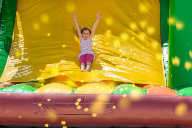 Photo of Beautiful girl playing in an inflatable playground