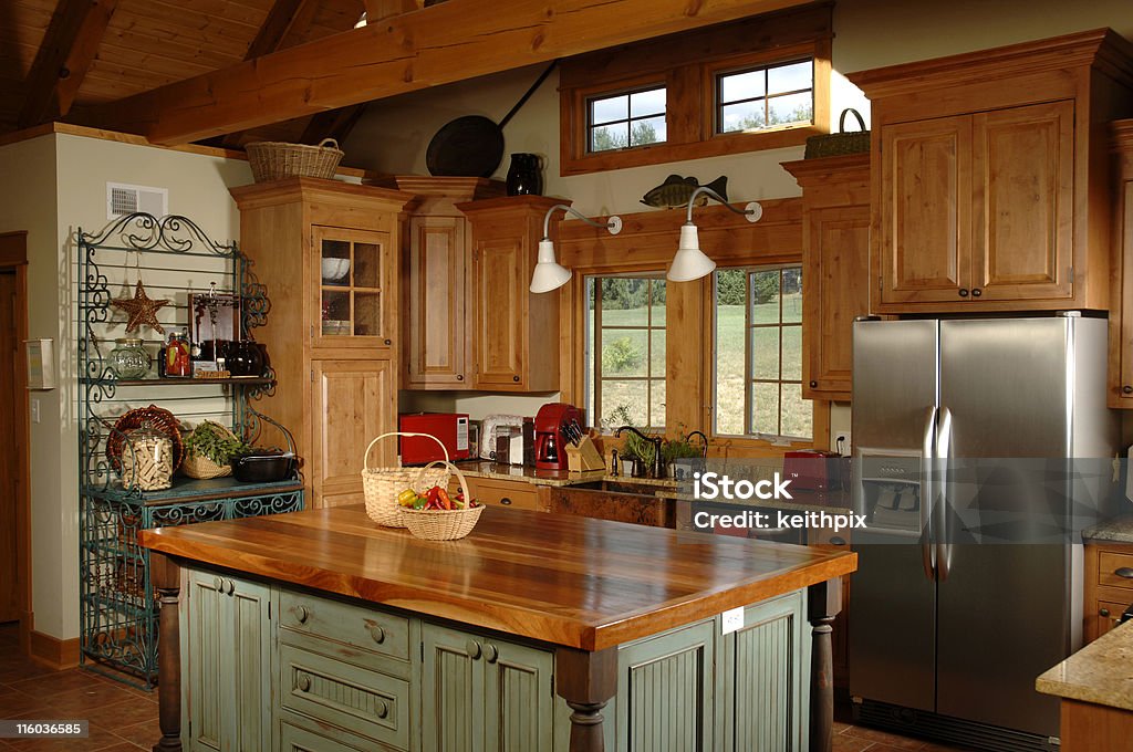 Country themed interior kitchen a country kitchen with a beautiful wooden butcher blco table Kitchen Stock Photo