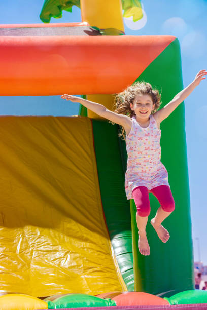istock Beautiful girl playing in an inflatable playground 1160366776