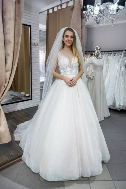 istock Beautiful bride in salon posing in wedding dress 1160367029
