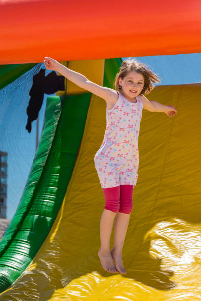 istock Beautiful girl playing in an inflatable playground 1160367213