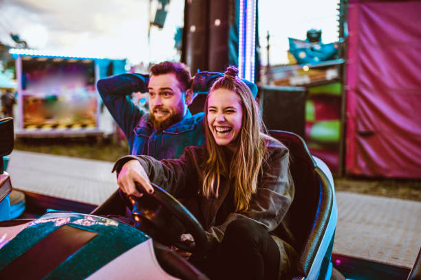 istock Scared Boyfriend Letting Girlfriend Drive Bumper Car 1160368424