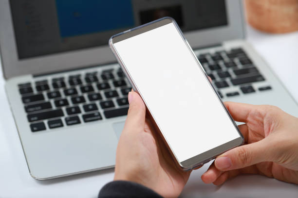 istock Businesswoman using smart phone and laptop 1160369334