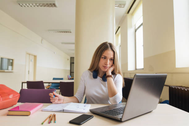 istock Student watching a video on her laptop 1160371594