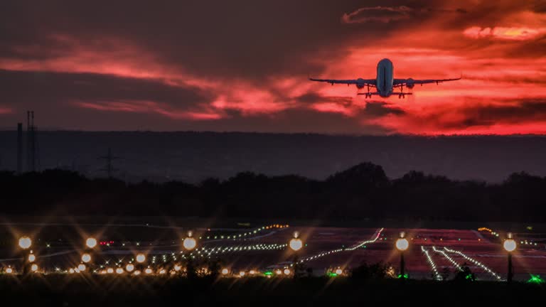 Airplane taking off at sunset