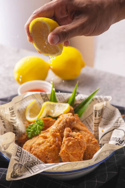 istock Fried chicken legs with lemon and parsley. 1160375873