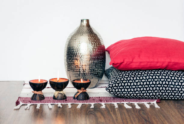 istock Cozy home interior decor, burning candles in coconut shell on a multi-colored rug 1160376501
