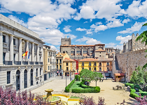 Avila, Spain - May 21, 2019: Elevated view of Plaza Adolfo Suárez, Avila, Spain. On the left, the Provincial Delegation of Economy and Finance, opposite, the city wall, background centre the Cathedral of the Saviour.