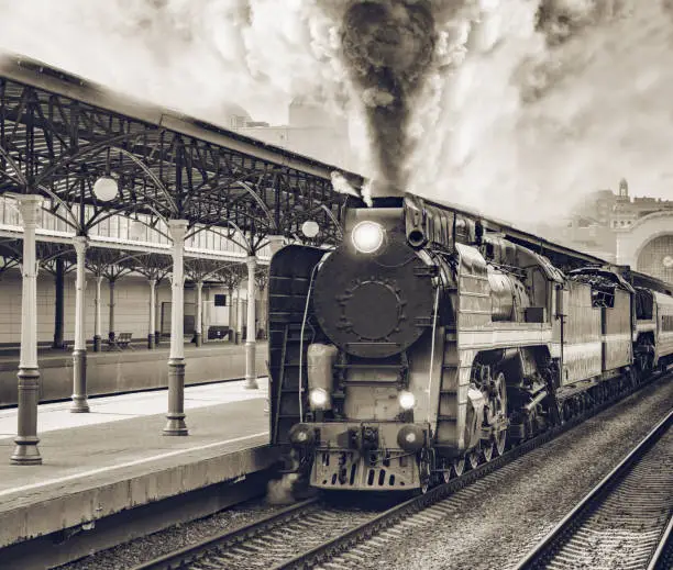 Photo of Retro train departs from railway station building.