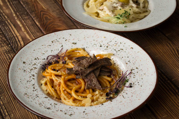 istock Pasta with tomato and meat on a wooden table. 1160378870
