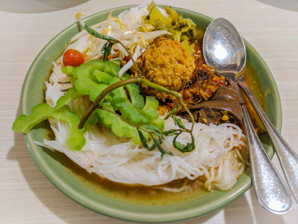 istock Rice noodles with chicken curry sauce and fresh vegetable. 1160378920