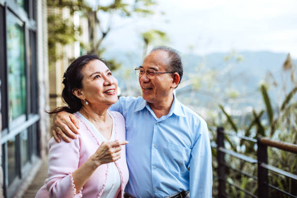 Joyful moments Smiling senior Taiwanese couple hugging in backyard chinese couple stock pictures, royalty-free photos & images