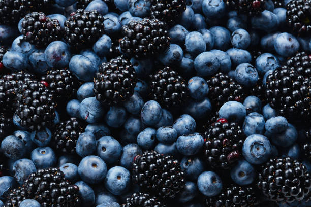 istock Blackberry and  blueberry background. Top view. 1160382990