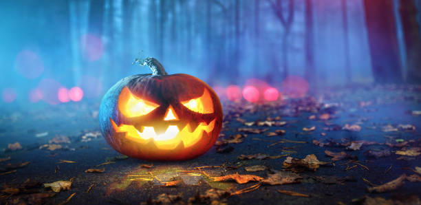 istock Halloween Pumpkins Glowing In Fantasy Night Forest 1160384124