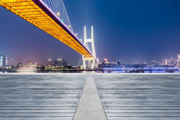 istock Shanghai Nanpu bridge and empty wooden floor scenery at night 1160384304