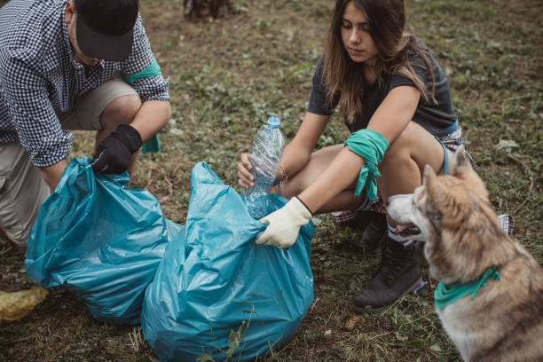 istock Ecologycally aware family cleaning park 1160384374