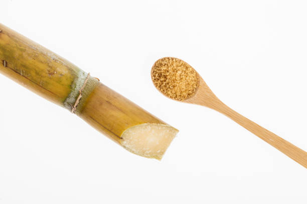 istock wooden spoon with brown sugar, on white background 1160384485