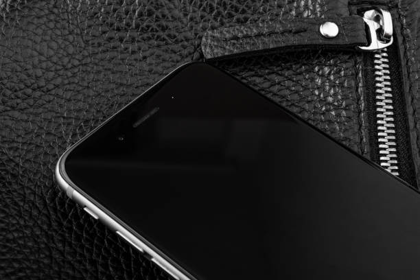 istock phone on black leather texture with zipper 1160384853