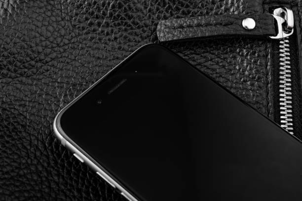 istock phone on black leather texture with zipper 1160384880