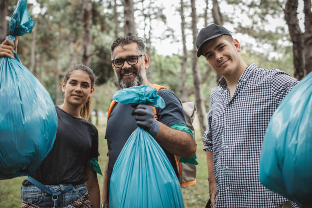 istock Family volunteers cleaning park 1160385563