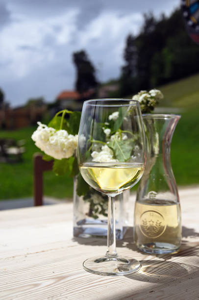 istock Glass of white wine on a table. 1160385640