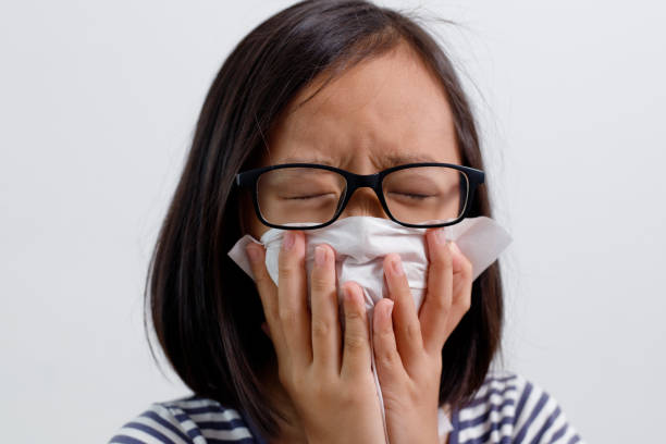 istock Little girl blowing he nose 1160385857