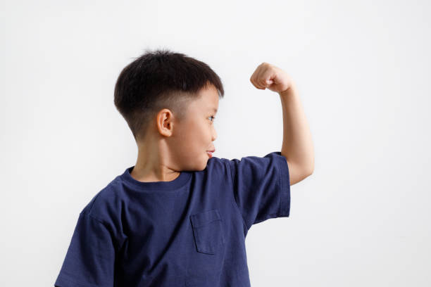 istock Little kid showing his muscle 1160387073