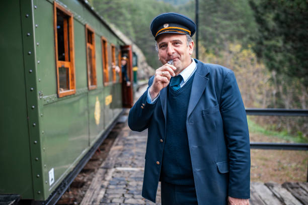 Train conductor gives a signal for the departure Train conductor gives a signal for the departure transport conductor stock pictures, royalty-free photos & images