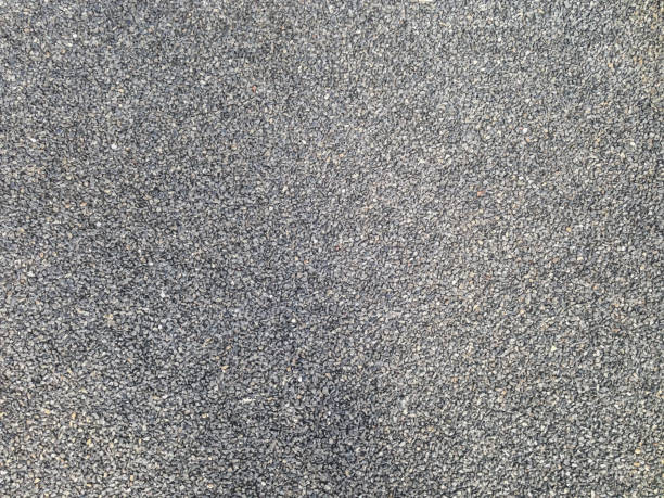 asphalt textured background of black fine-grained stones asphalt textured background of black fine-grained stones asphalt stock illustrations