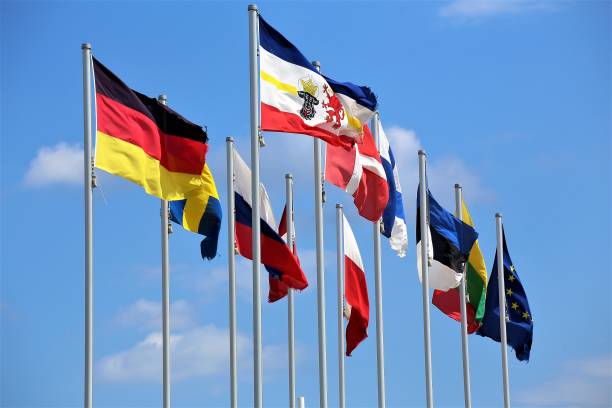 istock flags of different countries on background of blue sky 1160391027