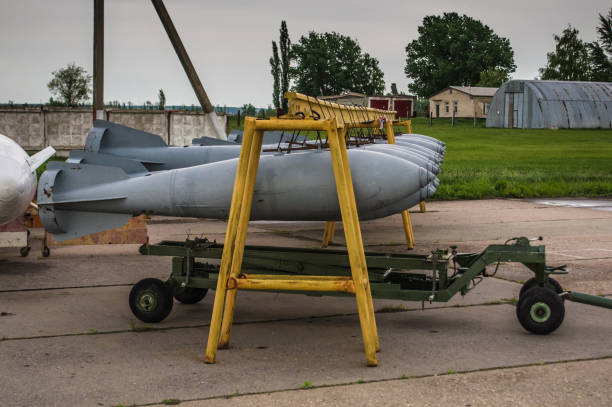 Aerial bombs fixed in line at closed military airfield.