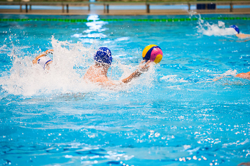 Water polo action in a swimming pool