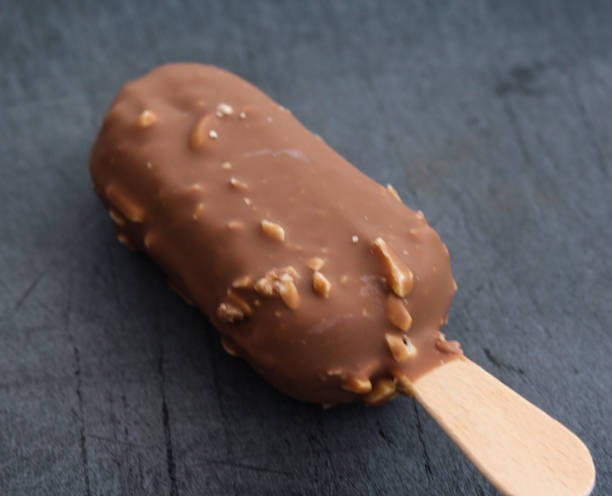 istock Vanilla milk chocolate almond bar ice cream on black background 1160399562