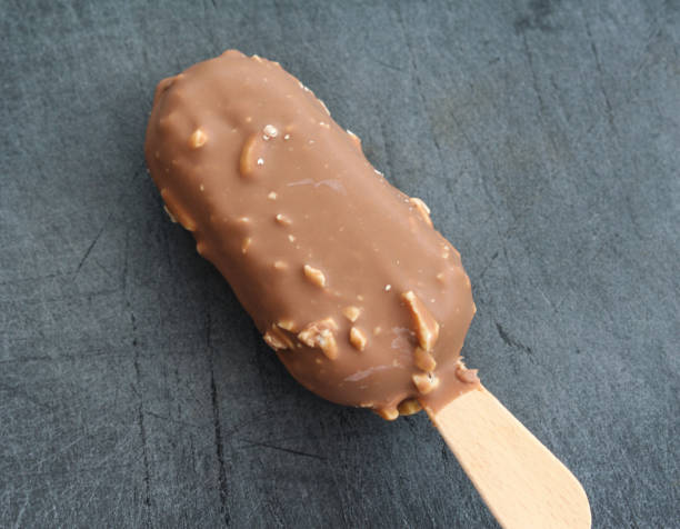 istock Vanilla milk chocolate almond bar ice cream on black background 1160399563