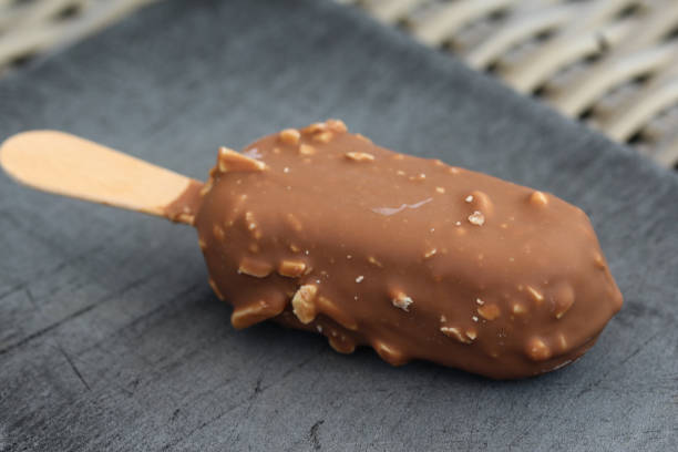 istock Vanilla milk chocolate almond bar ice cream on black background 1160399594