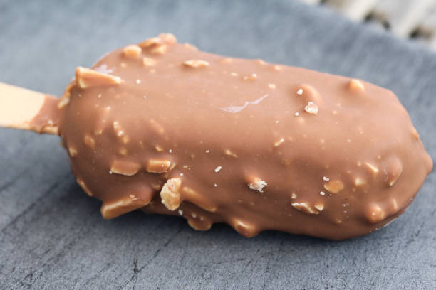istock Vanilla milk chocolate almond bar ice cream on black background 1160399619