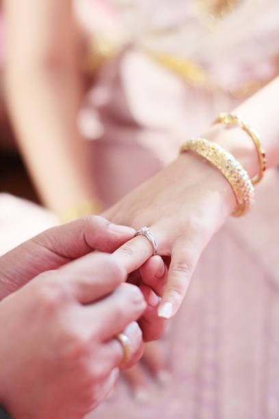 istock Groom hands holding bride hands with wedding ring in Thai wedding ceremony traditional. 1160399808