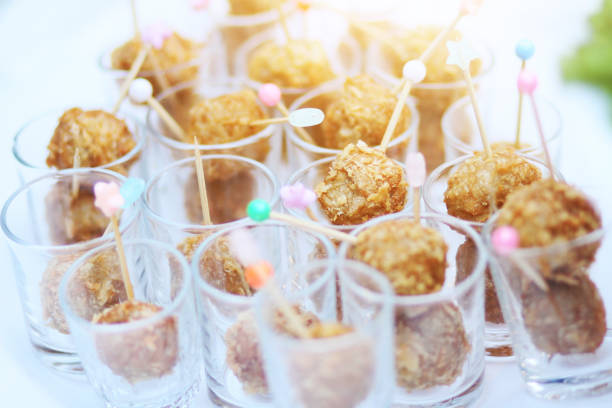 Thai Spring Roll and Fried meatballs in small glass cup decorated on buffet table